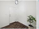 Clean entryway with a dark wood floor, white walls, and a simple, modern light fixture at 11207 Argosy Dr, Lancaster, SC 29707