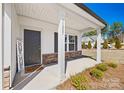 Inviting covered front porch featuring stone accents, neutral colors, and a welcoming entrance at 11207 Argosy Dr, Lancaster, SC 29707