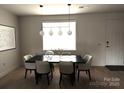 Dining room features modern lighting, a large window, and stylish decor creating an inviting atmosphere at 121 Irving Ave, Mooresville, NC 28117