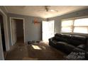 Cozy living room features neutral walls and natural light at 142 Fletcher Sw Ct, Concord, NC 28027