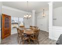 Bright dining room with a round table, six chairs, a window view, and stylish wainscoting and light fixtures at 156 Sugar Hill Rd, Troutman, NC 28166