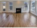 Spacious living room with hardwood floors and large windows, offering plenty of natural light at 15604 Waterfront Dr, Huntersville, NC 28078