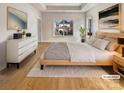Serene main bedroom with tray ceiling, wood floors, and a neutral color palette at 15604 Waterfront Dr, Huntersville, NC 28078