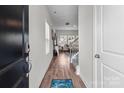 Inviting entryway with hardwood floors, a staircase, and a view into the open-concept living area at 2116 Belterra Dr, Charlotte, NC 28216