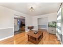 Open-concept living room with hardwood floors and views into the kitchen and dining room at 2156 Flynn Dr, Gastonia, NC 28054