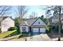An aerial view of a cozy home with a well-maintained lawn and two-car garage at 2316 Winding River Dr, Charlotte, NC 28214