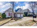 Inviting home with a two-car garage, beautiful landscaping, and a cozy, neighborhood feel at 2316 Winding River Dr, Charlotte, NC 28214