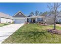 Charming single-story home featuring a manicured lawn, attached garage, and inviting front porch at 2455 Seagull Dr # 62, Denver, NC 28037