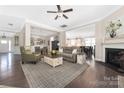 Open-concept living room featuring hardwood floors, neutral paint, and a cozy fireplace at 2455 Seagull Dr # 62, Denver, NC 28037