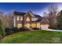 Charming two-story brick home with a well-manicured lawn and an attached two-car garage at 2835 Peverell Ln, Charlotte, NC 28270