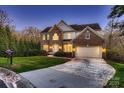 Charming two-story brick home with a well-manicured lawn and an attached two-car garage at 2835 Peverell Ln, Charlotte, NC 28270