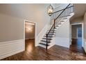 Elegant foyer features hardwood floors, staircase with iron spindles, and a decorative chandelier at 2835 Peverell Ln, Charlotte, NC 28270