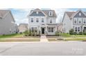 Traditional two-story home boasts well-kept landscaping, a covered entryway, and light gray exterior at 3017 Woodlands Creek Dr, Monroe, NC 28110
