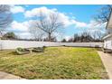 A wide open backyard with white fencing and raised garden beds offers lots of space at 308 W First St, Lowell, NC 28098