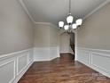 Elegant dining room featuring wood floors, wainscoting, and a stylish chandelier at 3420 Donnington Way, Gastonia, NC 28056