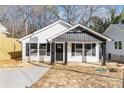 Charming home with white siding, black accents, and inviting front porch with well-lit entry for curb appeal at 42 Magnolia St, York, SC 29745