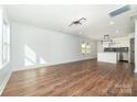 Open living area featuring wood floors and bright lighting connecting to the kitchen for modern appeal at 42 Magnolia St, York, SC 29745