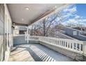 Spacious covered balcony with railing, offering a pleasant outdoor living space with ample sunlight at 433 W 8Th St, Charlotte, NC 28202