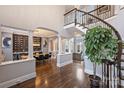 Spacious foyer featuring hardwood floors, open floor plan, wrought iron staircase, and dining area at 4335 Piper Glen Dr, Charlotte, NC 28277