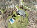 Aerial view of home nestled among trees, featuring a private backyard with a refreshing swimming pool at 501 Colonels Ct, Clover, SC 29710