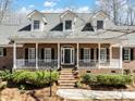 Charming brick home featuring a welcoming front porch with elegant columns and manicured landscaping at 501 Colonels Ct, Clover, SC 29710