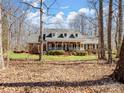 Well-maintained brick home with a welcoming front porch and mature trees surrounding the property at 501 Colonels Ct, Clover, SC 29710