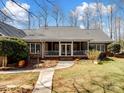 Charming brick home featuring a covered porch, mature landscaping, and a stone walkway at 501 Colonels Ct, Clover, SC 29710