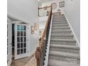 Spacious foyer featuring stairs to the second floor and french doors into another room at 5056 Blue Serenity Ct, Denver, NC 28037