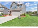 Well-maintained home with a spacious driveway and lush green lawn at 530 Silers Bald Dr, Fort Mill, SC 29715