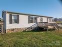 Charming home with vinyl siding, stone accent, and a welcoming front deck at 5448 Bill Sain Rd, Vale, NC 28168