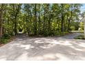 Large driveway with parking and trees surrounding the property at 601 Highland Forest Dr, Charlotte, NC 28270