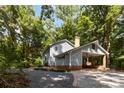 Rear elevation with a portico and view of the light blue siding and wood shake roof at 601 Highland Forest Dr, Charlotte, NC 28270