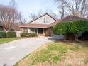 Charming home featuring a long concrete driveway and a well-maintained lawn at 6200 Summertree Ln, Charlotte, NC 28226