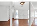 Bright, airy foyer with hardwood floors, high ceilings, and a decorative light fixture at 6200 Summertree Ln, Charlotte, NC 28226