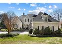 Charming home featuring a landscaped front yard, dark shutters, and a welcoming entryway with a black front door at 6403 Amos Smith Rd, Charlotte, NC 28214