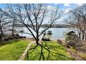 Scenic waterfront view with private docks and a well-manicured lawn leading to the water's edge at 6403 Amos Smith Rd, Charlotte, NC 28214
