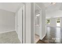 Bright hallway leading to a modern bathroom and spacious living area, highlighting the open layout at 769 River Park Rd, Belmont, NC 28012