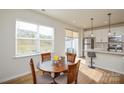 Cozy dining area featuring a wood table with four chairs next to the kitchen with stainless steel appliances at 1028 Grays Mill Rd, Charlotte, NC 28215