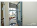 Inviting entryway with a view of the neighborhood featuring a gray front door with glass panels and a decorative rug at 1028 Grays Mill Rd, Charlotte, NC 28215