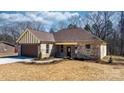 A cozy brick home featuring a garage, inviting walkway, and manicured landscaping at 105 4Th Se St, Catawba, NC 28609