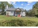 Quaint one-story home featuring a covered front porch, brick steps, and a neatly maintained lawn at 10633 Hwy 52 Hwy, Rockwell, NC 28138