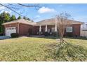 Lovely brick home with a well-maintained lawn, shrubbery, and inviting front porch at 112 Jobe Dr, Statesville, NC 28677