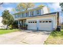 Lovely two-story home with a well manicured front yard, attached two-car garage, and light-blue window shutters at 11416 Leadenhall Ln # 22, Charlotte, NC 28262