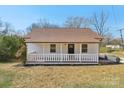 Charming home featuring a covered front porch, light colored siding, and a well-maintained lawn at 1156 9Th St, Lancaster, SC 29720