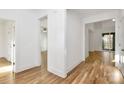 Bright hallway with hardwood floors and white trim leading to various rooms at 1157 Bunch Dr, Statesville, NC 28677