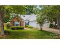 Attractive home with brick facade, white siding, well-maintained landscaping, and a two-car garage at 1286 Saint Katherines Way, Rock Hill, SC 29732