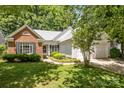 Beautiful home with a brick accent wall and siding on the front, as well as pretty landscaping at 1286 Saint Katherines Way, Rock Hill, SC 29732