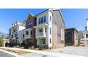 Charming townhome with modern architecture, a cozy balcony, and a well-maintained front yard at 3115 Pinehurst Pl, Charlotte, NC 28209