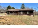 This single-story home has a covered porch and rustic wood siding at 132 Pisgah Church Rd, Statesville, NC 28625