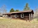 Side view of a single-story home featuring wood siding and a covered porch at 132 Pisgah Church Rd, Statesville, NC 28625